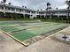 A shuffleboard court with multiple lanes is surrounded by lawn in this multi-Gathering residential property at 5335 Embassy Ave # 5335, New Port Richey, FL 34652