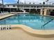 A clear view of the community swimming pool, showing its depth, entrance points, and relaxing lounge chairs at 5335 Embassy Ave # 5335, New Port Richey, FL 34652