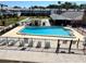 The community pool is fenced in and features a refreshing swimming area, lounge chairs, and seating at 5335 Embassy Ave # 5335, New Port Richey, FL 34652