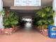 A covered walkway shows well-maintained landscaping and access to multiple units in this multi-Gathering residential property at 5335 Embassy Ave # 5335, New Port Richey, FL 34652