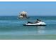 A Yamaha jet ski floats near a tiki bar boat in a calm blue ocean at 5335 Embassy Ave # 5335, New Port Richey, FL 34652
