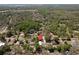 An aerial perspective pinpoints the location amidst lush trees, highlighting the home's position in the community at 5342 Leisure St, Dade City, FL 33523