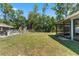 Spacious fenced backyard with a screened lanai, offering privacy and room for outdoor activities at 5342 Leisure St, Dade City, FL 33523