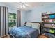 Cozy bedroom with ceiling fan, window view, and organized shelving at 5342 Leisure St, Dade City, FL 33523