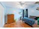 Bedroom with ceiling fan, natural light, and wood dresser at 5342 Leisure St, Dade City, FL 33523