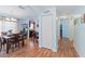 Inviting dining area with warm wood floors, complemented by light blue walls and modern light fixtures at 5342 Leisure St, Dade City, FL 33523