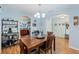 Dining room with ample light, modern shelving and decor, arched doorways leading to a bright kitchen at 5342 Leisure St, Dade City, FL 33523
