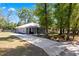 A beautifully landscaped property with a long driveway leading to a well-maintained single-story home at 5342 Leisure St, Dade City, FL 33523