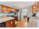 Traditional kitchen featuring wood cabinets, granite countertops, stainless steel appliances, and hardwood floors at 5342 Leisure St, Dade City, FL 33523