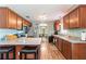 Traditional kitchen featuring wood cabinets, granite countertops, stainless steel appliances, and hardwood floors at 5342 Leisure St, Dade City, FL 33523