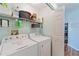 Functional laundry room with washer, dryer, and shelving at 5342 Leisure St, Dade City, FL 33523