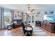 Inviting living room with hardwood floors, neutral walls, and French doors providing access to the outdoors at 5342 Leisure St, Dade City, FL 33523