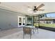 Enclosed patio with ceiling fan and outdoor seating area at 5342 Leisure St, Dade City, FL 33523