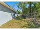 View of the side yard with an AC unit, home exterior, storage shed, and a chain-link fence at 5342 Leisure St, Dade City, FL 33523