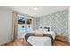 Bright bedroom with a floral accent wall and views of the pool through a large window at 5417 Carlton Rd, New Port Richey, FL 34652