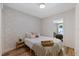 Cozy bedroom with patterned wallpaper and wood floors at 5417 Carlton Rd, New Port Richey, FL 34652