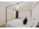 Bright bedroom featuring a four-poster bed, modern lighting, and double closets at 5417 Carlton Rd, New Port Richey, FL 34652