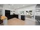 Bright open kitchen with sleek black cabinets, modern appliances, and an inviting dining area with backyard views at 5417 Carlton Rd, New Port Richey, FL 34652
