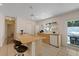 Bright kitchen featuring an island with a breakfast bar, modern appliances, and access to the outdoors at 5417 Carlton Rd, New Port Richey, FL 34652