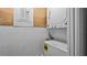 Laundry area featuring a stacked washer and dryer, plus a nearby circuit breaker for safety at 5417 Carlton Rd, New Port Richey, FL 34652