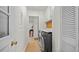 Clean laundry room with washer, dryer, storage cabinets and access to other rooms at 5417 Carlton Rd, New Port Richey, FL 34652