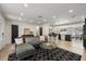 Spacious living room with modern furniture, a black and white rug, and an open view to the kitchen at 5417 Carlton Rd, New Port Richey, FL 34652