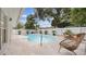 Inviting backyard pool surrounded by lush landscaping and a white privacy fence at 5417 Carlton Rd, New Port Richey, FL 34652
