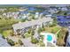 An aerial view of a waterfront condominium with a pool and canal access in a beautiful coastal setting at 5537 Sea Forest Dr # 301, New Port Richey, FL 34652