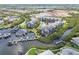 Expansive aerial view of condos, a boat dock, and a pool, highlighting community amenities at 5537 Sea Forest Dr # 301, New Port Richey, FL 34652