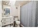 Bright bathroom with a shower, vanity, and storage shelves for fresh towels at 5537 Sea Forest Dr # 301, New Port Richey, FL 34652