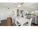 Open-concept dining and living area features a modern table and a view into the living room at 5537 Sea Forest Dr # 301, New Port Richey, FL 34652