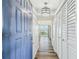 Entryway showcasing wood flooring, closet space, and a view into the bright kitchen and living area at 5537 Sea Forest Dr # 301, New Port Richey, FL 34652