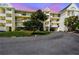 Exterior view of the condo building with balconies and lush landscaping, offering a glimpse of coastal living at 5537 Sea Forest Dr # 301, New Port Richey, FL 34652