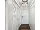 Hallway with wood floors, a storage closet, and neutral decor, offering functionality and style at 5537 Sea Forest Dr # 301, New Port Richey, FL 34652