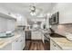 Bright kitchen featuring white cabinets, granite countertops, stainless steel appliances, and wood floors at 5537 Sea Forest Dr # 301, New Port Richey, FL 34652