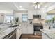 Well-lit kitchen boasts stainless steel appliances, granite countertops, and wood-look flooring at 5537 Sea Forest Dr # 301, New Port Richey, FL 34652