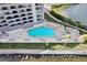 Aerial view of the complex's pool with lounge chairs and tables at 6035 Sea Ranch Dr # 305, Hudson, FL 34667