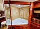 Bathtub with jets and tile walls at 6035 Sea Ranch Dr # 305, Hudson, FL 34667