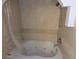 Bathtub with jets, tile walls, and shower head at 6035 Sea Ranch Dr # 305, Hudson, FL 34667