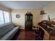 Bedroom includes wooden writing desk, wooden bookcase, ship models, wooden floors, and futon at 6035 Sea Ranch Dr # 305, Hudson, FL 34667