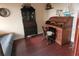 Bedroom includes wooden writing desk, wooden bookcase, ship models, and wooden floors at 6035 Sea Ranch Dr # 305, Hudson, FL 34667