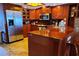 Large kitchen with stainless steel appliances, wood cabinets, and a serving bar at 6035 Sea Ranch Dr # 305, Hudson, FL 34667