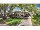 Charming home with a covered carport, well-kept lawn, and beautiful mature landscaping at 6124 Crestview Ln, Zephyrhills, FL 33542