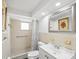 Small bathroom design featuring a single sink, shower, toilet and framed mirror at 6422 Tralee Ave, New Port Richey, FL 34653