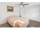 Bright bedroom featuring ceiling fan, carpet flooring, and closet at 6422 Tralee Ave, New Port Richey, FL 34653