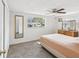 Simple bedroom with standard window, closet door, carpet and ceiling fan at 6422 Tralee Ave, New Port Richey, FL 34653