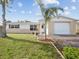 Charming single-story home featuring a manicured lawn, well-kept landscaping, and a welcoming front entrance at 6422 Tralee Ave, New Port Richey, FL 34653
