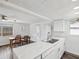Bright kitchen featuring white cabinets, stainless appliances and a dining area at 6422 Tralee Ave, New Port Richey, FL 34653