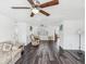 Bright living room featuring hard floors, ceiling fan, and neutral paint at 6422 Tralee Ave, New Port Richey, FL 34653