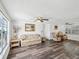 Spacious living room featuring wood-look flooring, comfortable seating, and a well-lit atmosphere at 6422 Tralee Ave, New Port Richey, FL 34653